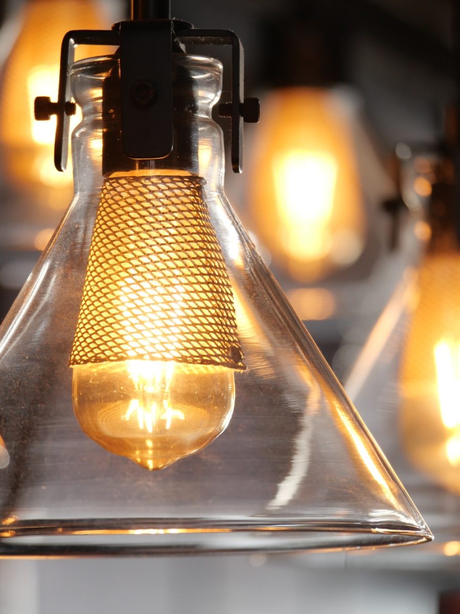 Warm glow of hanging glass light fixtures in a modern space